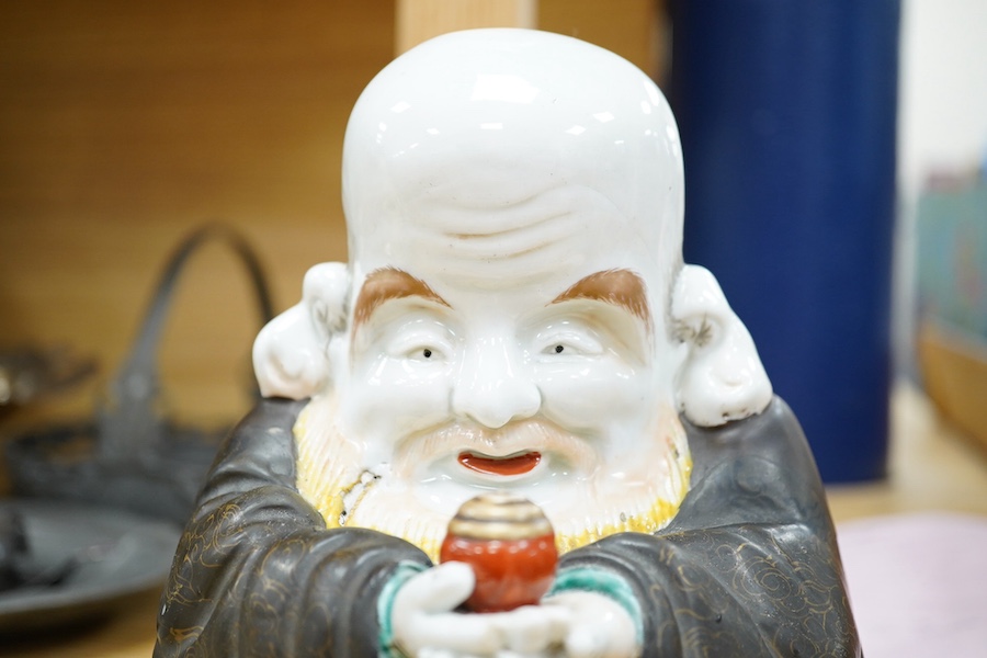 A Japanese green Kutani porcelain figure of Fukurokuju, 19cm. Condition - poor, large hairline crack across back shoulders and to base